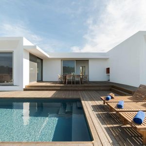 Lounge chairs in modern villa pool