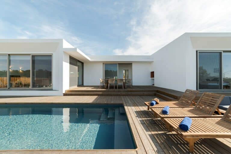 Lounge chairs in modern villa pool